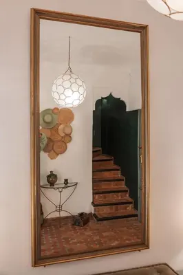 a mirror with a reflection of a staircase in a room at Riad Agathe & Spa in Marrakech