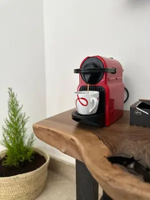 a red toaster sitting on a wooden table at Zara Apartments Marrakech in Marrakech