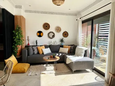 a living room with a couch and a table at Zara Apartments Marrakech in Marrakech