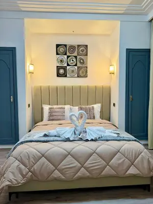 a bedroom with a bed with a heart decoration on it at Zara Apartments Marrakech in Marrakech