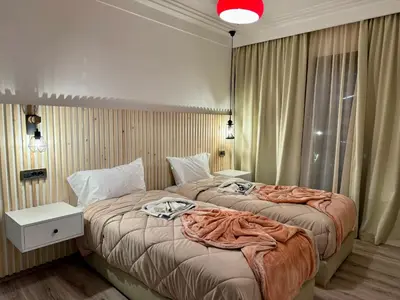 a hotel room with two beds and a red light at Zara Apartments Marrakech in Marrakech