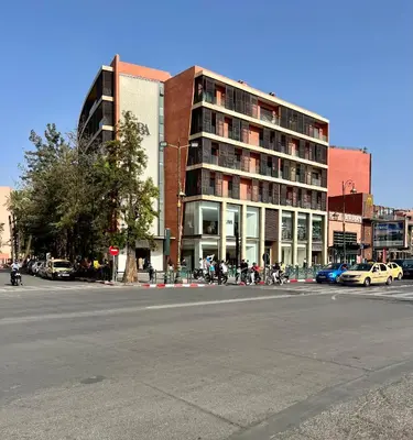 a large building on a city street with a building at Zara Apartments Marrakech in Marrakech