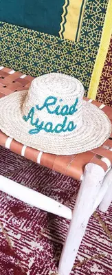 a cake on a table with a hat on it at Riad Ayada in Marrakech