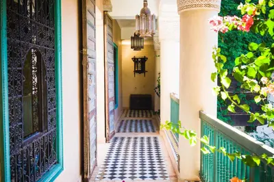 a hallway of a house with a door and a tiled floor at DAR CHIBANIA in Marrakech