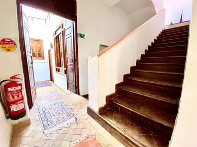 a staircase leading up to a room with a door at Riad Mandalay in Marrakech