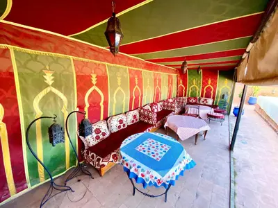 a living room with a couch and a table at Riad Mandalay in Marrakech