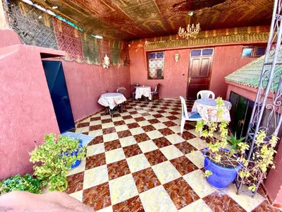 a patio with a checkered floor in a house at Riad Fattouma Kasba in Marrakech