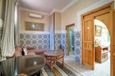 a living room with a couch and a table at Riad Inaka in Marrakech
