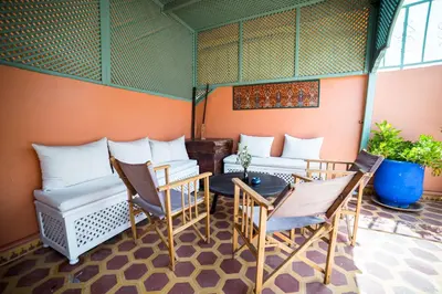 a group of chairs and tables in a room at Riad Inaka in Marrakech