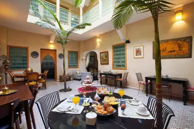 a dining room with a table with food on it at Riad Inaka in Marrakech