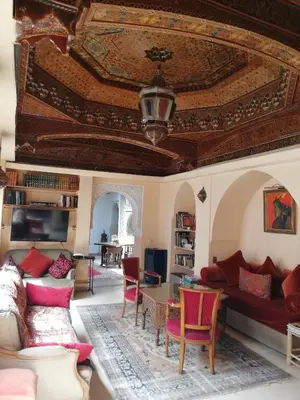 a living room with a couch and a table at Riad Ben Youssef in Marrakech