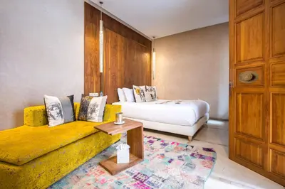 a living room with a bed and a couch at Riad Houma in Marrakech