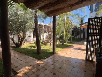 a walkway with palm trees in a park at Oloft in Marrakech