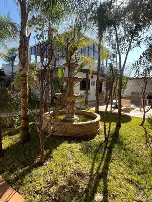 a fountain in the middle of a yard with trees at Oloft in Marrakech