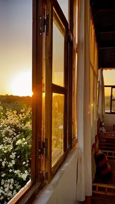 an open window with a view of a field of flowers at Oloft in Marrakech