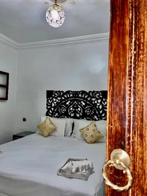 a bedroom with a bed with a black and white headboard at Oloft in Marrakech