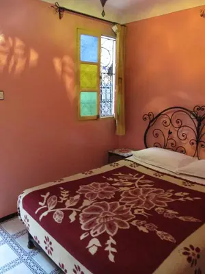 a bedroom with a bed and a window at Sindi Sud in Marrakech
