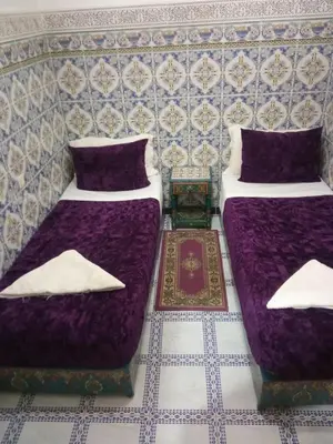 two beds sitting next to each other in a room at Sindi Sud in Marrakech