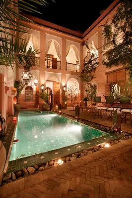 a swimming pool in the middle of a house at Riad Zagouda in Marrakech