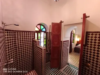 a room with a door and a window at Riad Zagouda in Marrakech