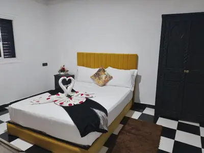 a bedroom with a bed with a bow on it at Hôtel Agnaou in Marrakech