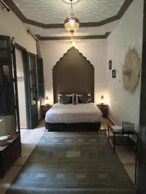 a bedroom with a large bed in a room at RIAD KERDOUSS in Marrakech