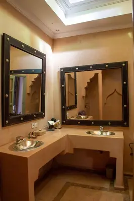 a bathroom with two sinks and a large mirror at RIAD KERDOUSS in Marrakech