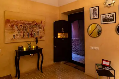 a hallway with a door and a table and a mirror at RIAD KERDOUSS in Marrakech