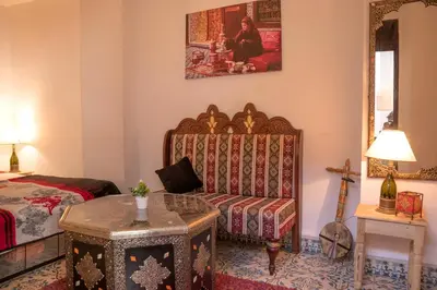 a living room with a couch and a bed at house miss rose in Marrakech