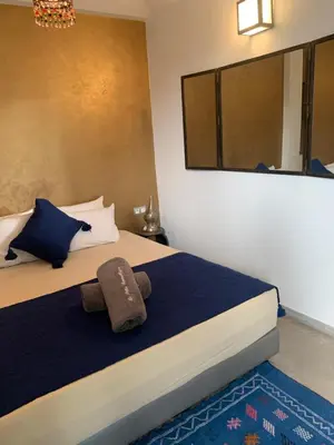 a bedroom with a bed with a stuffed animal on it at RIAD LE PATIO ROMANTIQUE in Marrakech