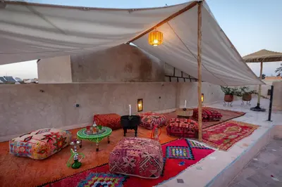a tent with couches and a table and candles at Riad Salman in Marrakech