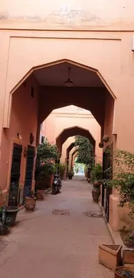 an archway in a building with potted plants at Riads Dar ZAO - logements entiers in Marrakech