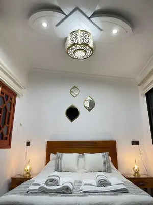 a bedroom with a bed with towels on it at Riads Dar ZAO - logements entiers in Marrakech