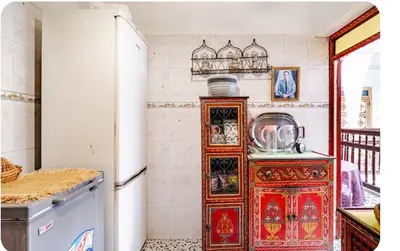 a kitchen with a dresser and a refrigerator at Riad zen&zin in Marrakech