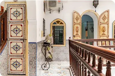 a hallway of a home with a staircase with a dog on the floor at Riad zen&zin in Marrakech