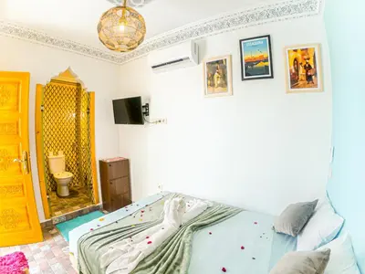 a bedroom with a bed and a mirror at Riad Dar Yassine in Marrakech