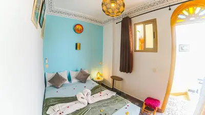 a bedroom with a bed with towels on it at Riad Dar Yassine in Marrakech
