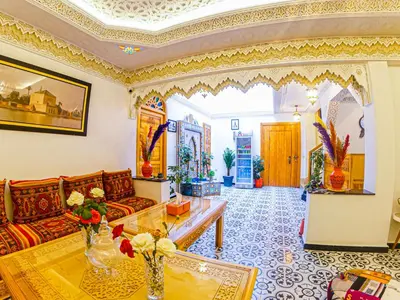 a living room with a couch and a table at Riad Dar Yassine in Marrakech