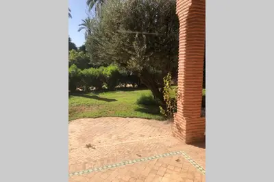 a view of a garden from a brick pillar at Bel appartement au Rez-de-jardin dans la palmeraie in Marrakech
