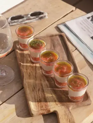 a wooden tray with small cups of food on a table at Jnan Lotf Marrakech - Le Jardin de la Bienveillance in Marrakech