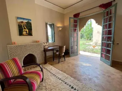 a living room with a couch and a table at Privat Villa in Marrakesch with Pool & Garten in Marrakech