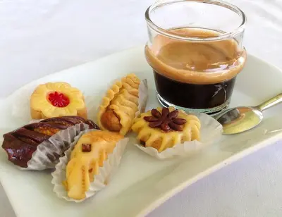a plate of pastries and a glass of coffee at Villa Selma avec piscine chauffée in Marrakech
