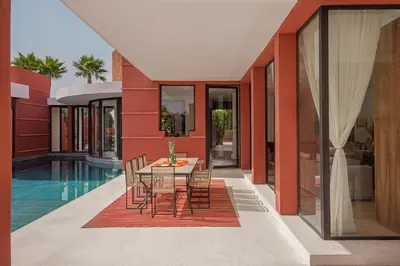 a dining room with a table and chairs in a house at Villa LOULA in Marrakech