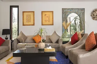 a living room with couches and a table at Villa LOULA in Marrakech