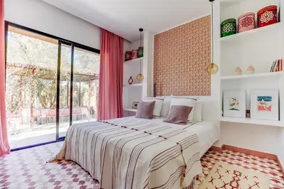 a bedroom with a bed and a large window at Villa ZITOUNA in Marrakech