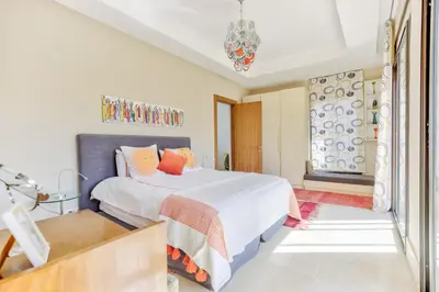 a bedroom with a bed and a window at Villa ZITOUNA in Marrakech