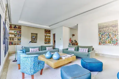 a living room with blue couches and a table at Villa ZITOUNA in Marrakech