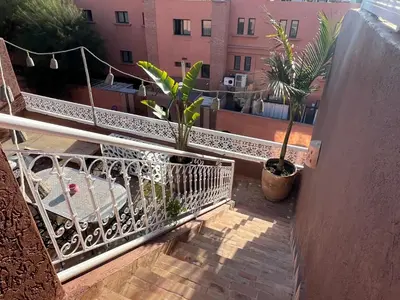 a balcony with two potted plants on a building at 