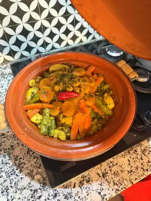 a bowl of food with carrots and other vegetables at 