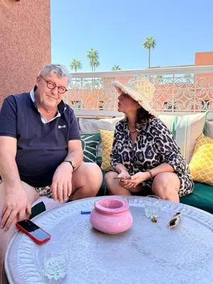 an older man and woman sitting around a table at 